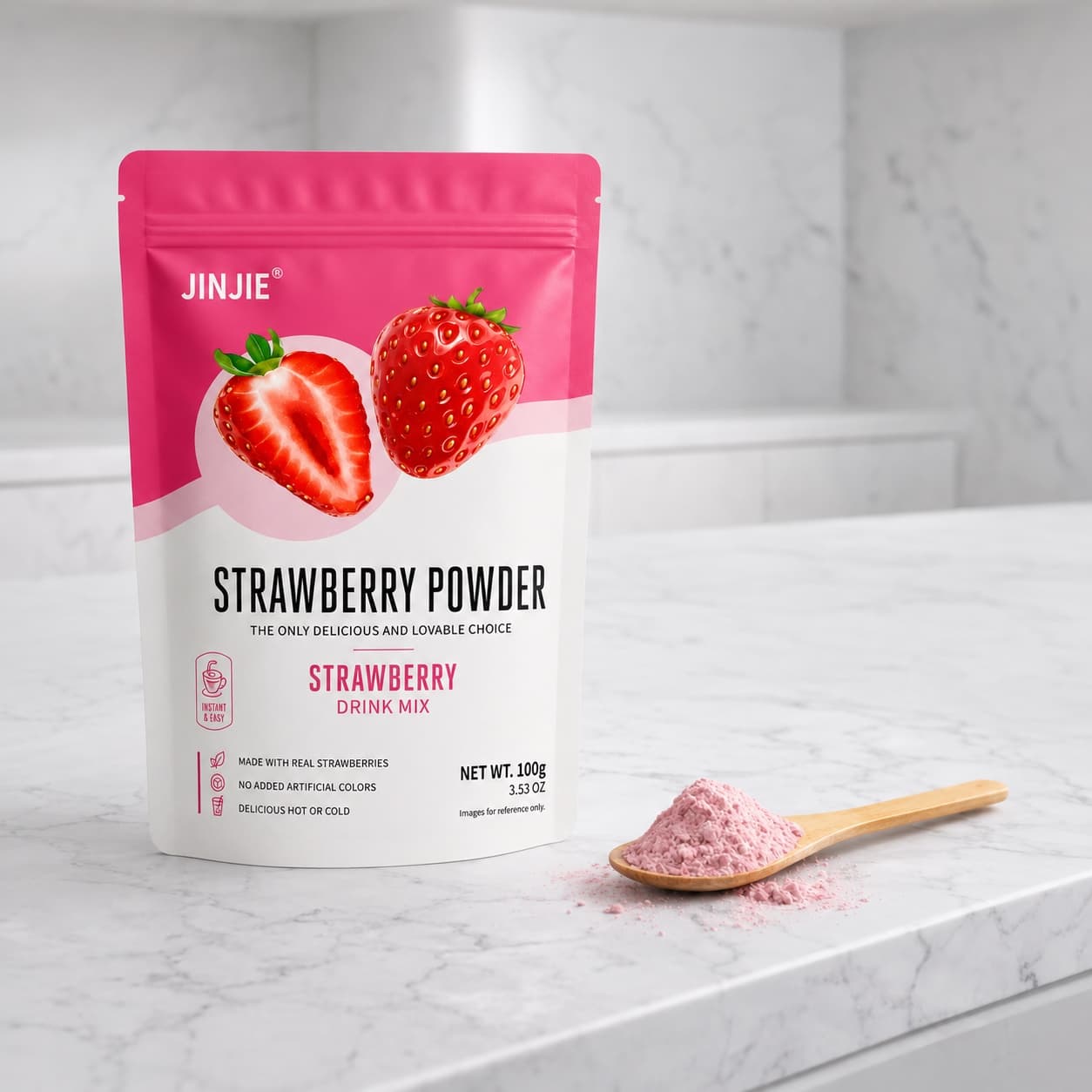 The 100g strawberry powder pouch standing on a marble counter beside a wooden spoon of pale pink powder