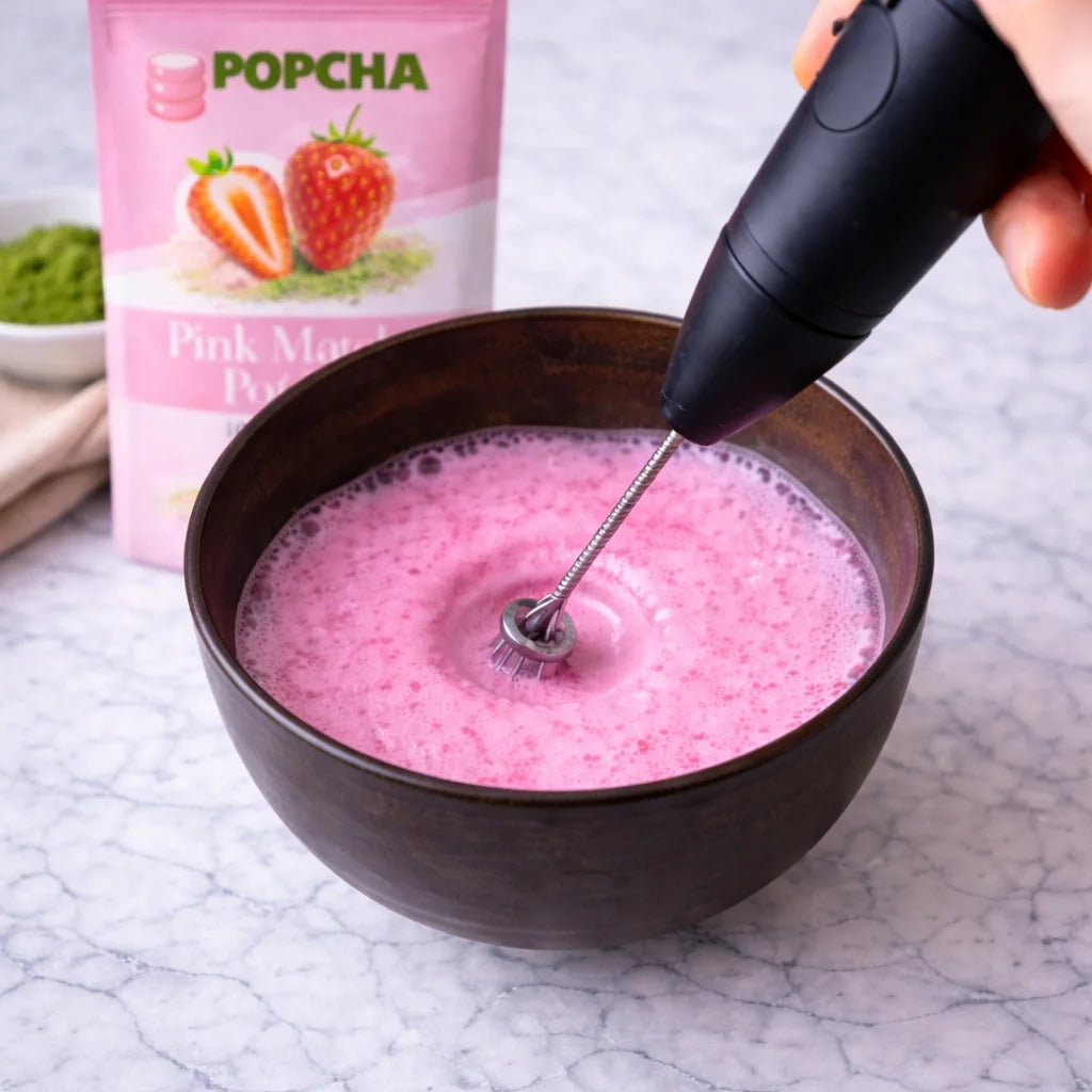 Mixing pink matcha powder with milk